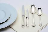 elegant table setting with silverware on white cloth