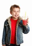 Happy healthy boy holding fresh fruit juice in clear cup