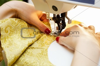 working on the sewing machine