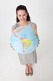 Beautiful businesswoman holding a terrestrial globe