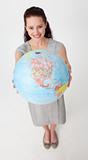 Smiling businesswoman holding a terrestrial globe