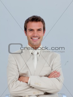 Portrait of smiling businessman with folded arms