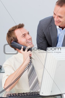 Businessman on phone talking to his colleague in the office