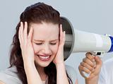 Angry businesswoman listening to a megaphone