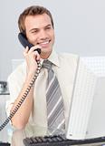 Businessman talking on phone in the office and working with a co