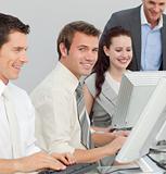 Businessman and his colleagues working with computers in an offi
