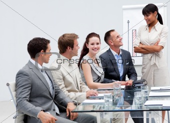 Smiling businesswoman listening to his colleague giving a presen