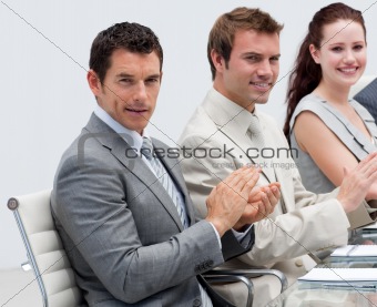 Attractive businessman applauding in a meeting