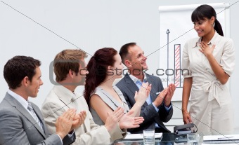 Business people applauding a colleague after giving a presentati