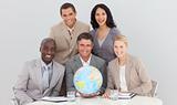 Business team holding a terrestrial globe