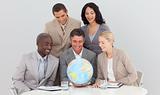 Multi-ethnic business team holding a terrestrial globe