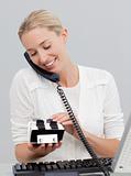 Businesswoman on phone and looking at an index holder