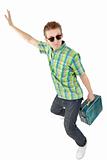 Funny young man with a suitcase in his hand