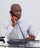 Afro-American businessman on phone in the office