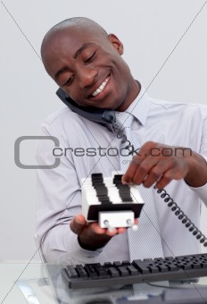 Businessman on phone and looking at an index holder