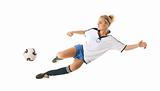 Female football player in the jump-kicks the ball
