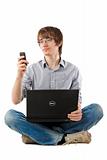 Young man with laptop and writing sms