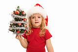 Little girl holding small decorated tree at christmas time