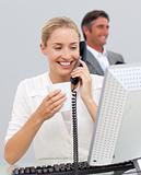Smiling businesswoman drinking coffee and talking on phone