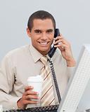 Young businessman talking on phone in the office