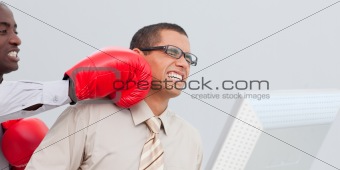 Young businessman being boxed in the office