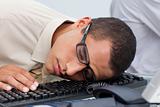 Young businessman sleeping on the keyboard