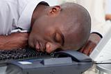 Afro-American businessman sleeping on the keyboard
