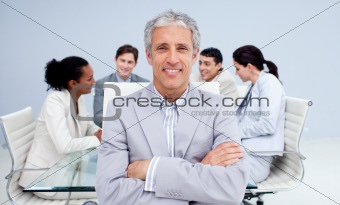 Confident senior businessman smiling in a meeting