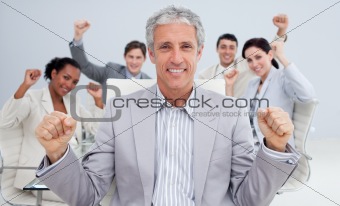 Happy businessman celebrating a sucess with his team