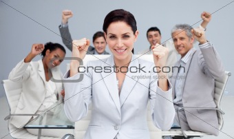 Happy business people celebrating a sucess with hands up
