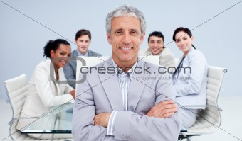 Mature businessman smiling in a meeting