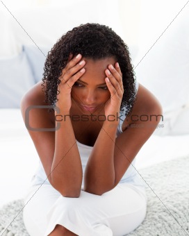 Afro-amrican woman having a headhache
