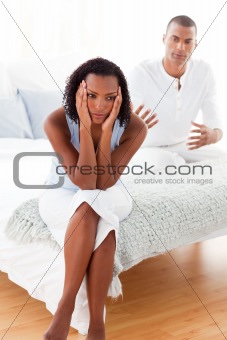 Angry couple sitting on the bed