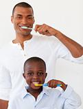 Father and his son brushing their teeth