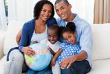 Afro-american family holding a terrestrial globe