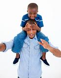 Dad giving son piggyback ride with closed eyes