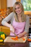Woman Slicing Produce in Kitchen