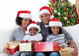 Afro-American family holding Christmas presents