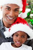 Portrait of a smiling father and daughter at Christmas time