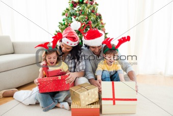 Happy family opening Christmas presents