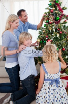 Happy Family hanging decorations on a Christmas tree