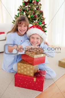 Happy brother and sister holding Christmas presents