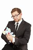 Businessman sitting and looking at the plush toy