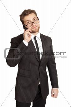 Businessman in a suit talking on the phone. Isolated over white