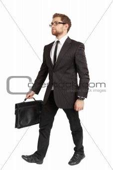 Business man in a suit and sunglasses comes with a briefcase