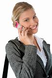 Attractive young business woman talking on a mobile phone agains