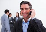 Portrait of smiling businessman on phone