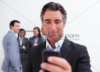 Confident manager sending a text with a mobile phone