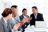 Happy business people clapping in a meeting