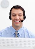 Confident businessman with headset on in a call center
